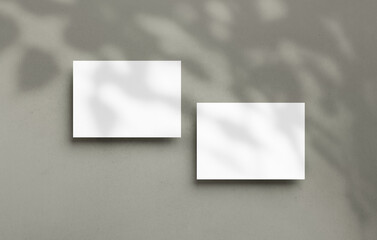 Postcard mockup empty double sided template with overlay shadow on a textured background. Blank paper card for design