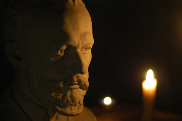 Gypsum figure of the composer Tchaikovsky in the studio with lighting and filters effect from the candle cinematographic effect