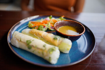 Fresh Vietnamese summer rolls on a colorful plate. 