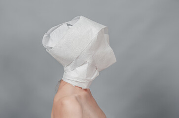 Naked female body in profile. The head is wrapped in white paper. Threat concept.