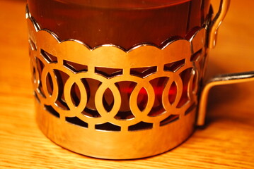 a glass in a metal, decorative basket © TK_Office