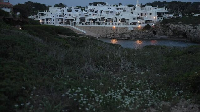 Whitewashed buildings in Binibeca Vell at dusk, Punta Prima, Menorca, Balearic Islands