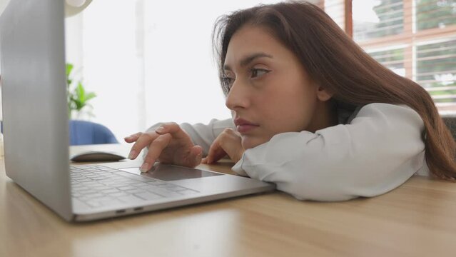 woman tired of work and not inspiration lazy apathetic look at laptop