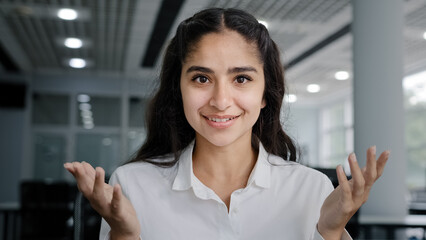 Headshot young positive woman business agent sales consultant makes presentation looking at camera...
