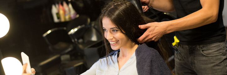 Young woman getting new hairstyle from hairdresser in the modern hair salon