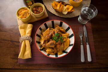 Noodles bolognese with chicken wings peru peruvian gourmet restaurant popular comfort food