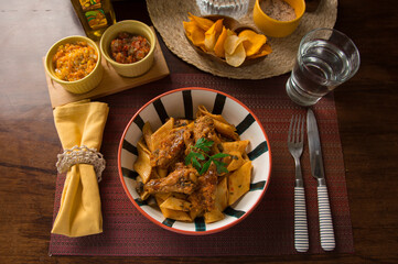 Noodles bolognese with chicken wings peru peruvian gourmet restaurant popular comfort food