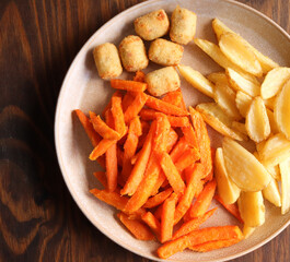 Chips, wedges and chicken nuggets. Sweet potato fries with potato wedges and chicken nuggets 