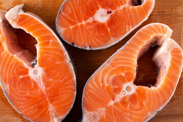 salmon steaks on a wooden board, close-up