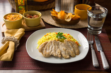 Light chicken filet and yellow rice Peruvian gourmet restaurant food