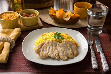 Light chicken filet and yellow rice Peruvian gourmet restaurant food