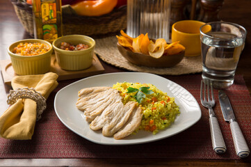 Light chicken filet and yellow rice Peruvian gourmet restaurant food