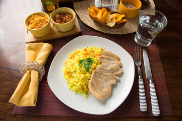 Light chicken filet and yellow rice Peruvian gourmet restaurant food