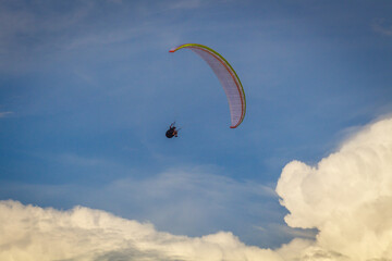 A person paragliding across the sky.