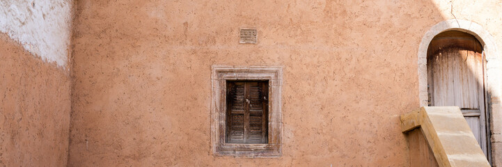 Fototapeta na wymiar Old wooden window stone wall house Morocco 