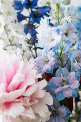 Naklejka na ściany i meble delicate bouquet of delphiniums and large pink peony
