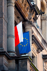 Flag of Poland and the European Union on an administrative building.