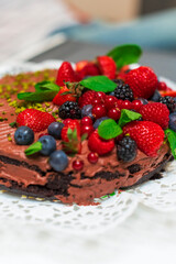 Delicious vegetarian chocolate cake with berries and pistachio  - 526317275