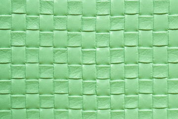 Green leather woven texture background. Green braided leather texture. Green texture for background.