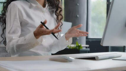 Close-up young woman teacher sitting at desk near computer communicates via video call conducts lesson webinar on online conference female professional advisor remotely consulting client using webcam