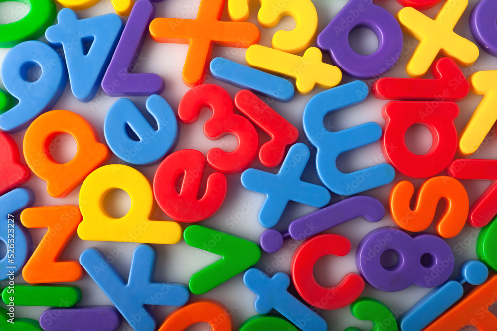 Fototapete plastic multi-colored alphabets letters on a magnet. lots of сolorful letters scattered on a white b