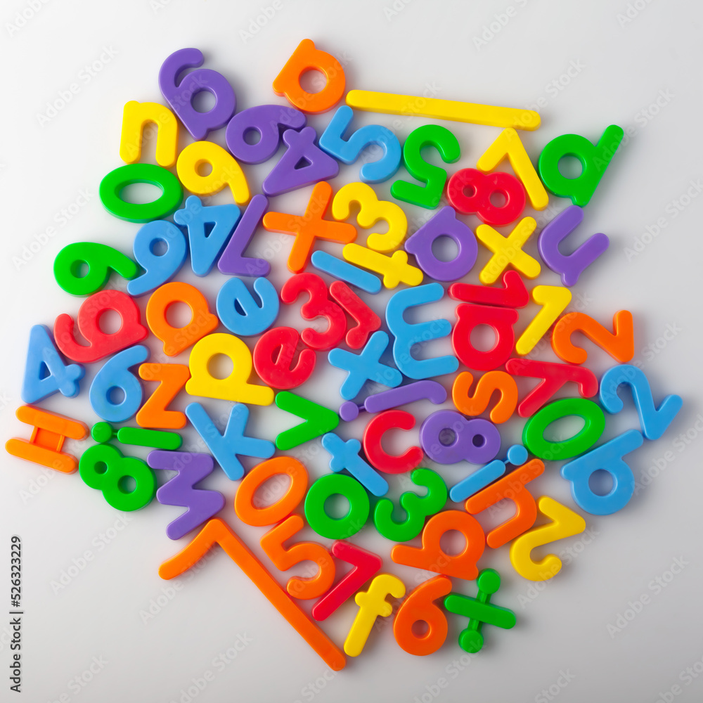 Fototapete plastic multi-colored alphabets letters on a magnet. lots of сolorful letters scattered on a white b