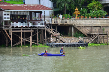 Thai man fisher people sailing plastic paddle long tail boat fishery floating catch fishing marine and fish in chao phraya river in Ayutthaya city on May 1, 2014 in Phra Nakhon Si Ayutthaya, Thailand