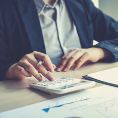 Accounting businessmen are calculating income-expenditure and analyzing real estate investment data, Dedicated to the progress and growth of the company, Financial and tax systems concept.