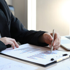 Financial businessmen analyze the graph of the company's performance to create profits and growth, Market research reports and income statistics, Financial and Accounting concept.