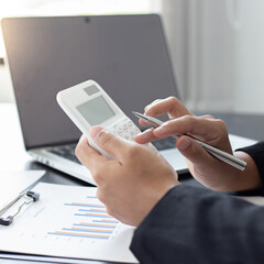 Accounting businessmen are calculating income-expenditure and analyzing real estate investment data, Financial and tax systems concept.