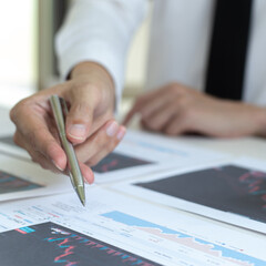 Naklejka premium Accountants and financiers are brainstorming the analysis of revenue performance with stock graphs at meetings, Analysis of real estate investment and income tax data concept.