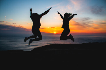 People jumping at sunset