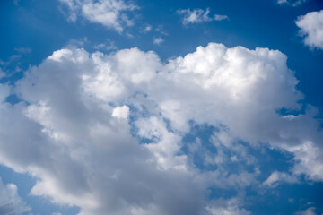 Naklejka na ściany i meble Natural sunny blue sky background with beautiful puffy white cumulus clouds