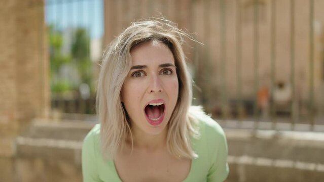 Young woman standing with surprise expression at street