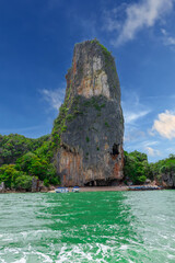 Fototapeta na wymiar Phangna Bay near the Island of Phuket Thailand. Lovely rock in the middle of the ocean surrounded by mountains
