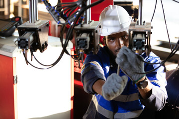 African engineer or worker checking and fixing machine in robot factory © offsuperphoto