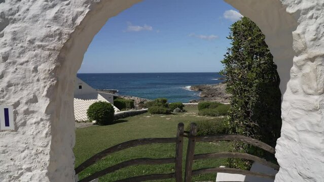 Whitewashed archway overlooking the Mediterranean Sea in Binibeca Vell, Binibeca Vell, Menorca, Balearic Islands