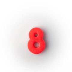 Plastic magnetic number 8 eight red on a white background top view.