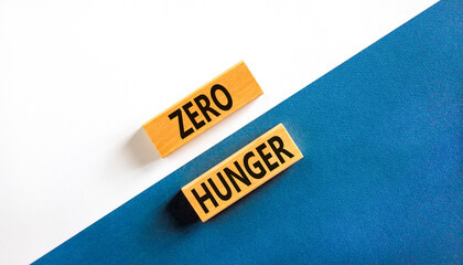 Zero hunger symbol. Concept words Zero hunger on wooden blocks on a beautiful white and blue...