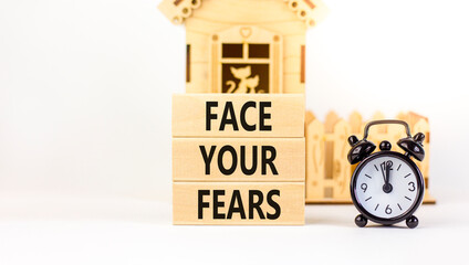 Face your fears and support symbol. Concept words Face your fears on wooden blocks. Black alarm...