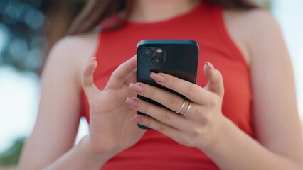 Young caucasian woman using smartphone at street - Powered by Adobe