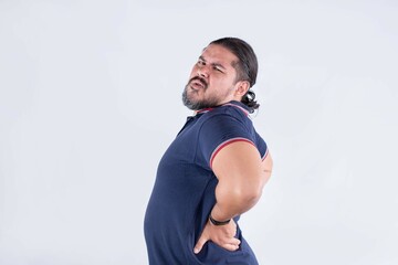 A man feeling lower back pain in the lumbar region. Suffering from a bulging or ruptured disk....
