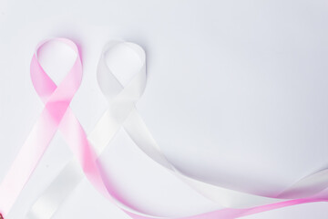 Pink ribbon fight against breast cancer and white ribbon to fight violence against women on...