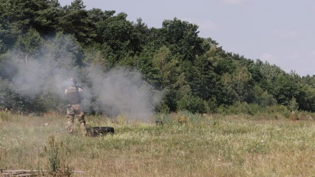 The soldier is wearing a helmet, uniform, and body armor when he fires a Precision Shoulder-Fired Rocket Launcher RPG-7 PSRL-1 at his enemy with a rocket that is precisely on target.