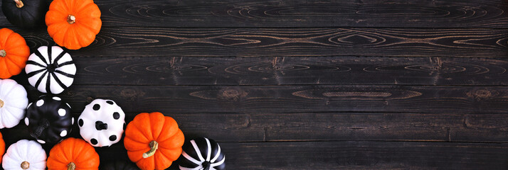 Halloween pumpkin decor corner border. Orange, black and white patterns against a black wood banner...