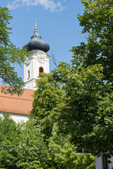 A city view of the town Bad Aibling in Bavaria, Germany. View of a church tower in the city center.