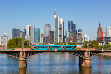 Frankfurt skyline with Main river and tram on Ignatz Bubis Bridge travel traveling in Germany - obrazy, fototapety, plakaty