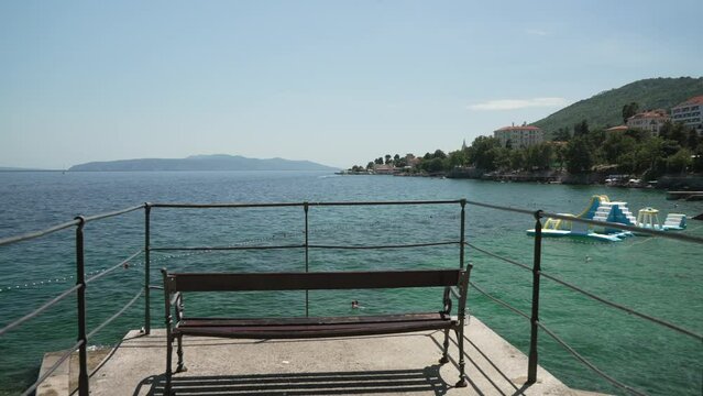 Trees, people and coastline of Adriatic Sea with Lovran in background, Lovran, Eastern Istria
