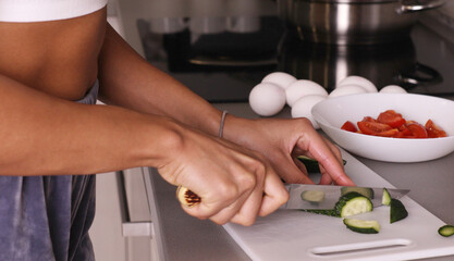 Obraz na płótnie Canvas Human hands cooking vegetables salad in kitchen.