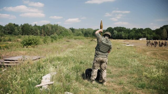 An army serviceman prepares the Precision Shoulder-Fired Rocket Launcher, PSRL-1, RG-7, for firing.